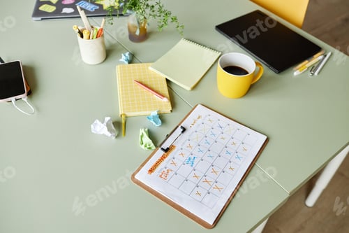 Preview: Calendar on Clipboard with Work Meetings Planned Resting on Desk in Office