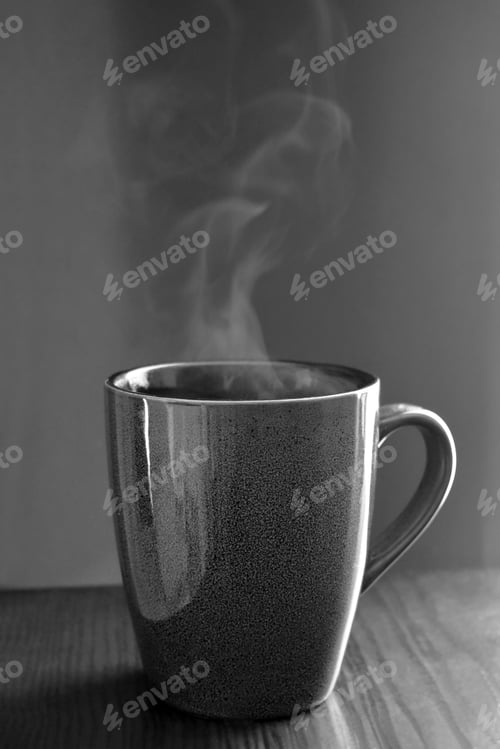 Preview: Cup of tea or coffee with steam. Black and white vintage photo.