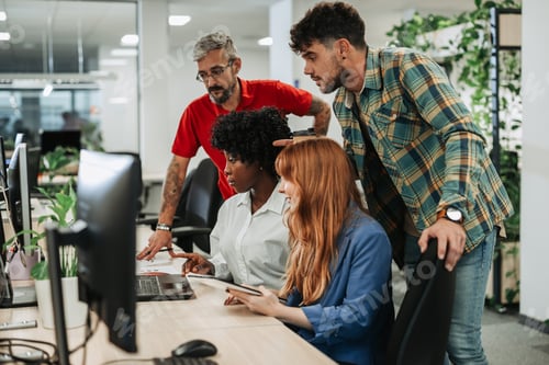 Preview: Diverse business team using laptop during a meeting in the office
