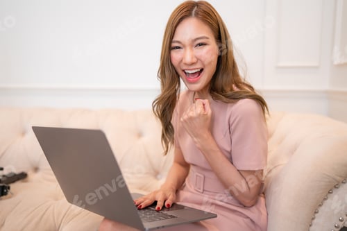 Preview: Happy and smiling businesswoman typing on laptop.