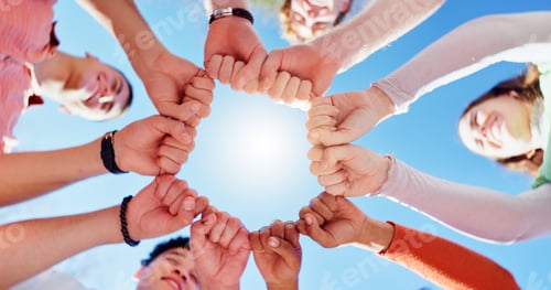 Preview: Friends, people and group with fist bump or below for teamwork, unity and support in circle outdoor