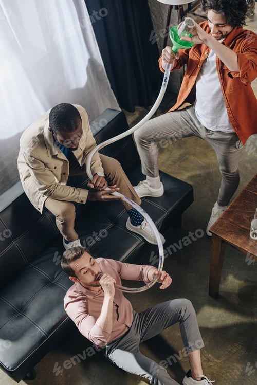Preview: high angle view of smiling multiethnic friends drinking beer from beer bong