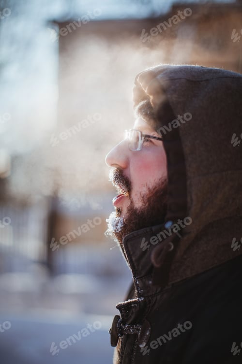 Preview: Bearded man exhales steam on the street in winter