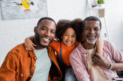 Preview: Three Smiling Family Members Posing Together Inside