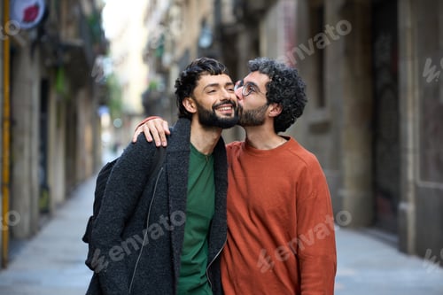 Preview: Gay couple kissing on cheek while walking down street