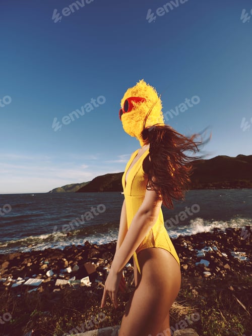 Preview: Beach, woman, yellow swimsuit a woman in a yellow swimsuit stands on the beach by the ocean, with
