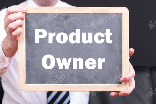 Preview: Businessman wearing a suit and holding a blackboard with the phrase product owner written on it