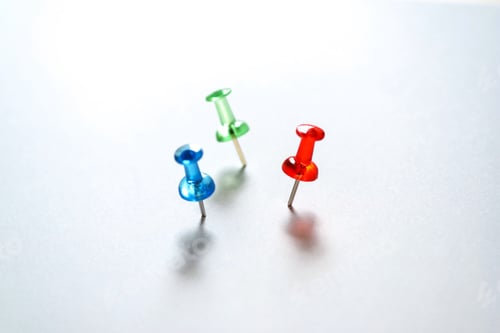 Preview: Blue green and red pushpins on the white background. Three pushpins