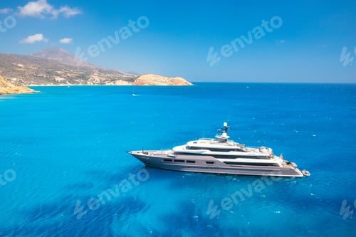 Preview: Multideck yacht in a bay with azure water. Summer holidays and trips on the ship.