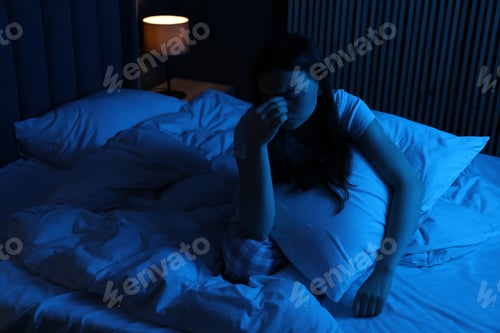 Preview: Frustrated woman with pillow suffering from insomnia on bed at home