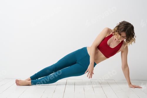 Preview: woman in leggings is engaged in gymnastics in a light room slim figure fitness sport