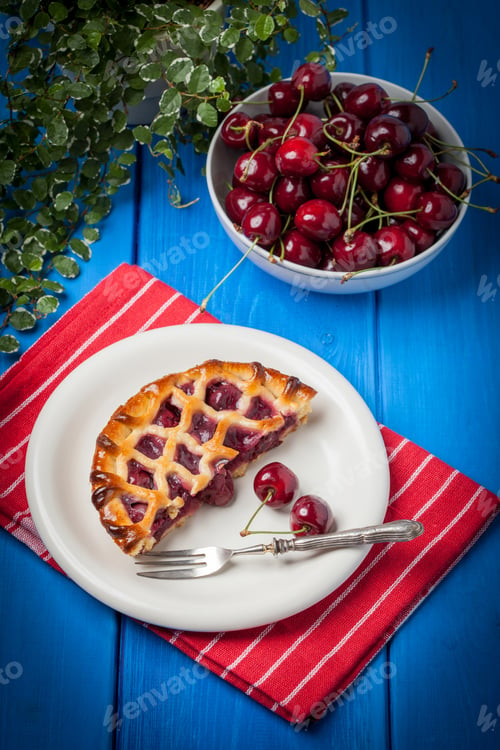 Preview: Homemade cherry pie on blue table.