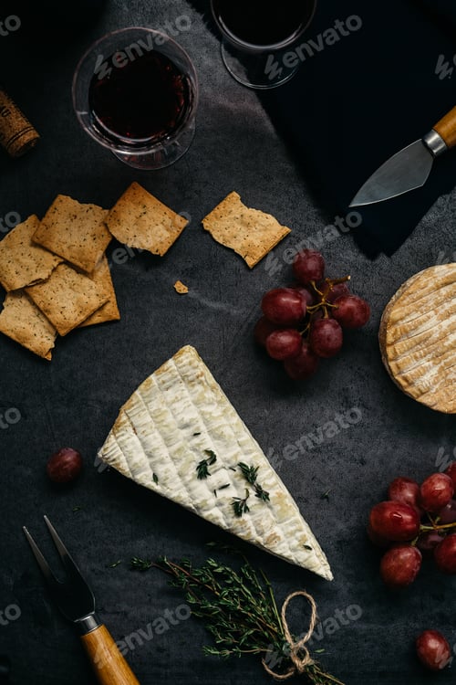 Preview: Cheese, Grapes, and Wine on Dark Surface