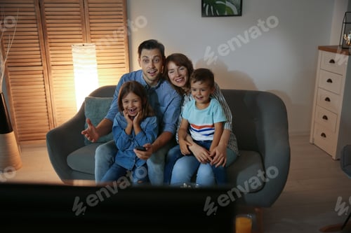 Preview: Family watching TV in room at evening time