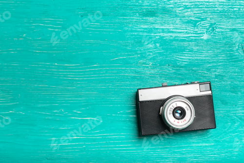 Preview: Old retro camera on wooden table background