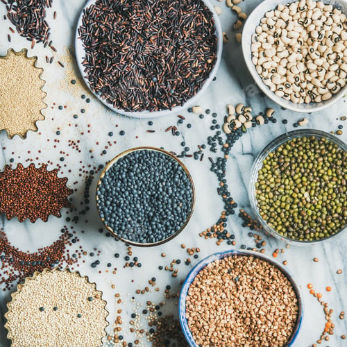 Preview: Variety of raw grains, beans, cereals, marble background, square crop