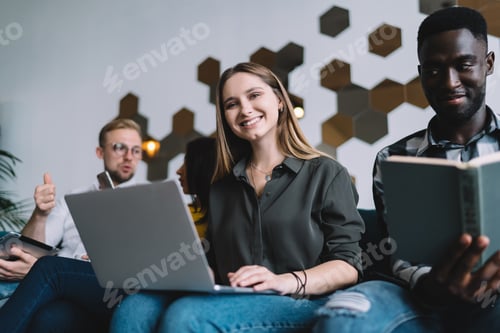 Preview: Optimistic woman with laptop on couch