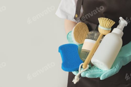 Preview: Housekeeping person wearing gloves and apron holding various cleaning tools and detergents