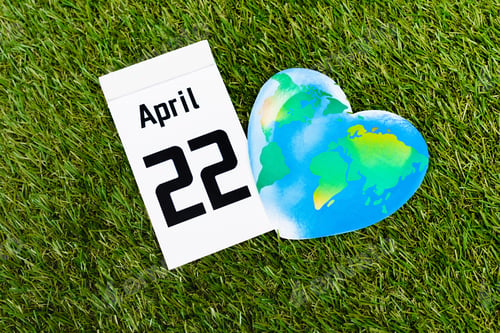 Preview: Top view of calendar with 22 april inscription and globe on green background, earth day concept