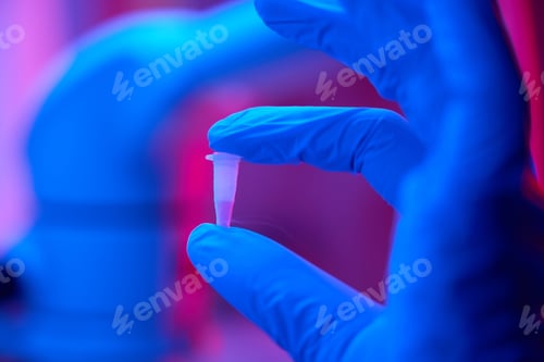 Preview: Man in protective gloves holds a small test tube