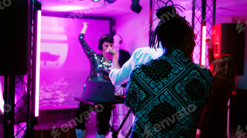 Preview: Young adult putting music at party