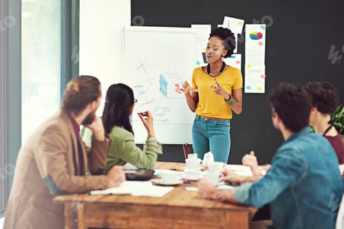 Preview: Cropped shot of a young creative giving a presentation to her colleagues in an office