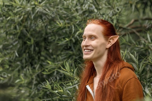 Preview: Artistic elf man with red hair and green eyes in the forest