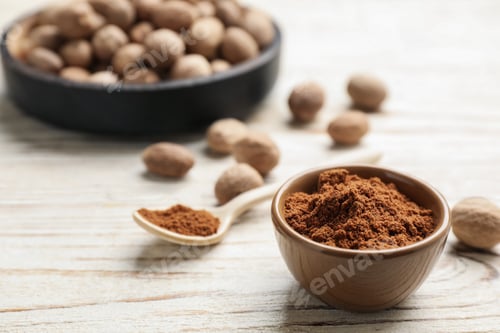 Preview: Bowl of nutmeg powder on white wooden table, space for text