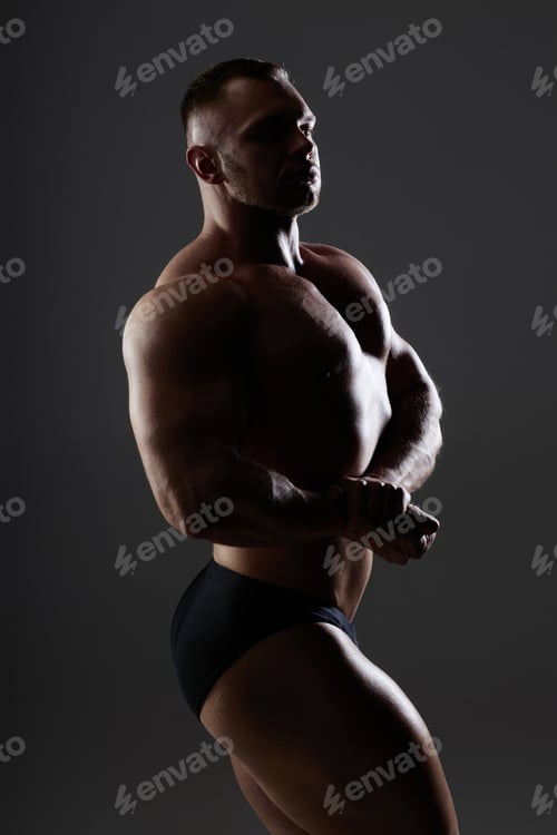 Preview: Topless Sportsman Flexing Chest Musculature In Low Key
