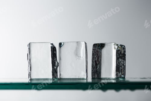 Preview: Selective Focus of Melting Transparent Clear Square Ice Cubes Isolated on White