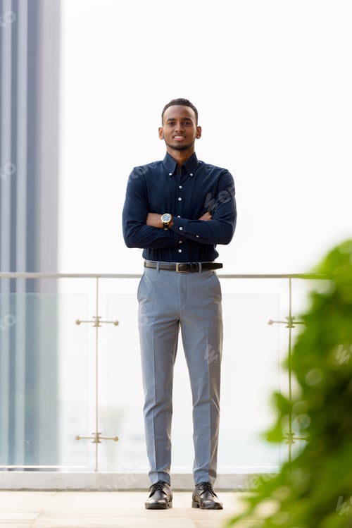 Preview: Full length shot of confident African businessman outdoors at rooftop