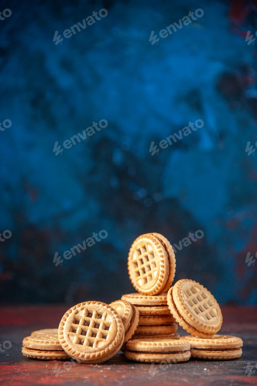 Preview: Side view of delicious cookies arranged in different forms and flower on mix colors background with