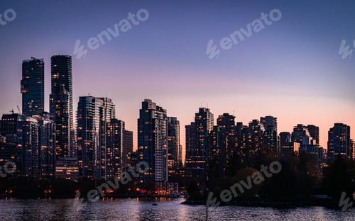Preview: Wide-angle lens of illuminated skyscrapers at sunset