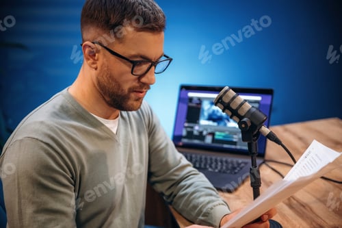 Preview: Reading the text. Man with microphone in the studio, conception of podcast