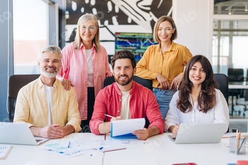 Preview: Diverse business team smiling working together in office