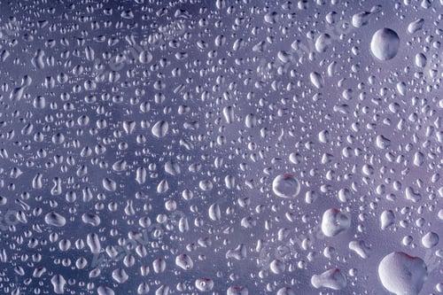 Preview: Water drops on window glass. Small droplets. Rainy wet glass, autumn background