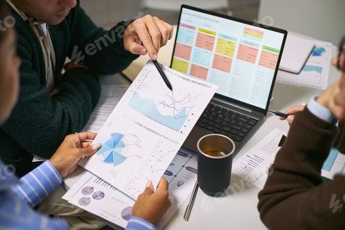 Preview: Multiethnic Young Adults Analyzing Financial Charts during Business Meeting