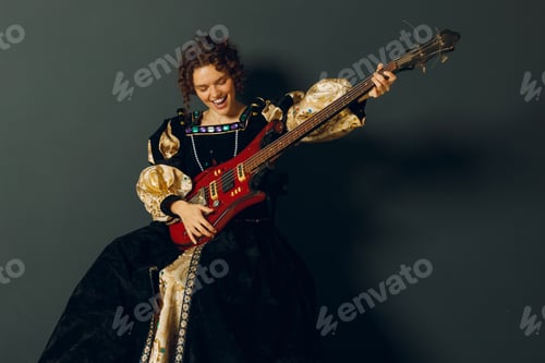 Preview: Portrait of a young adult woman playing music on electric guitar and dressed in a medieval dress.
