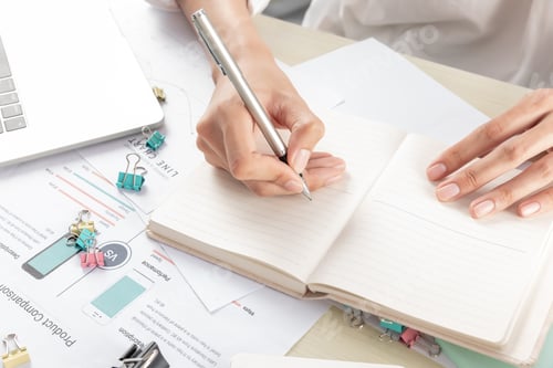 Preview: Hand of businesswoman writing on paper in the office