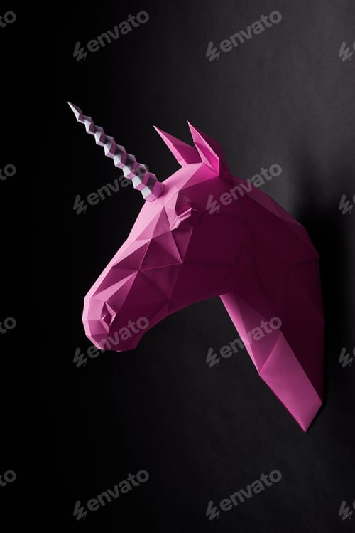 Preview: Saturated pink unicorn's head hanging on black wall