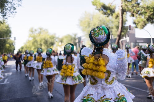 Preview: Hispanic dancers walking in formation during a street parade. Dia de la hispanidad