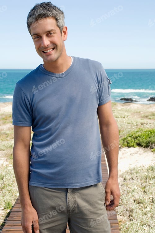Preview: Man smiling on a sunny beach boardwalk
