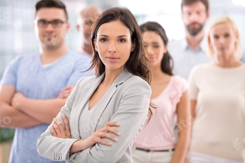 Preview: Shot of a confident businesswoman standing in front of her coworkers