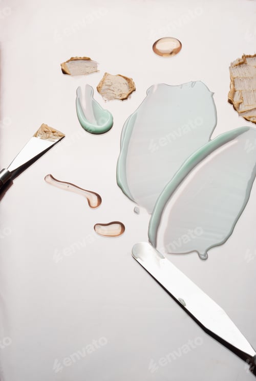 Preview: Multicolored samples of cosmetic products and palette knife