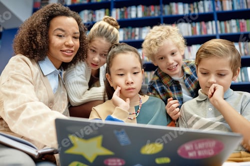 Preview: Children Looking at Laptop Screen with Smiling Teacher