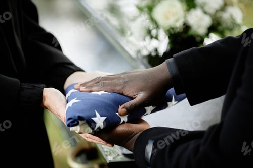 Preview: Close up of general handing folded American flag to woman