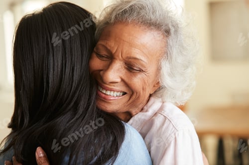Preview: Over The Shoulder View Of Senior Mother Being Hugged By Adult Daughter At Home