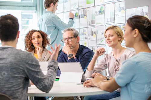 Preview: Digital design team discussing at conference table