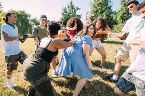 Preview: Group of friends dancing in park