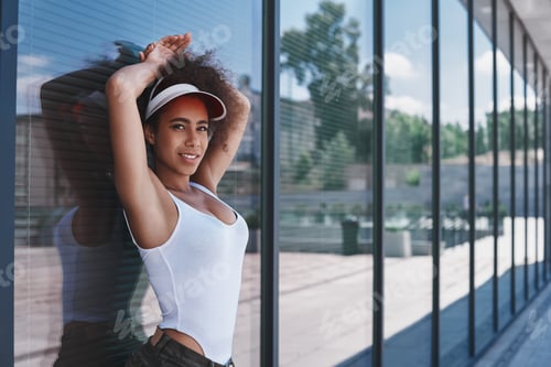 Preview: Young woman in visor free style on the street leaning on window